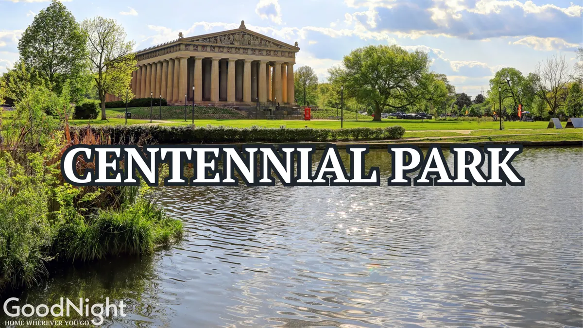 A picturesque view of Nashville's Parthenon replica, surrounded by lush greenery and calm water in Centennial Park. It radiates tranquility and cultural significance, inviting exploration and relaxation.